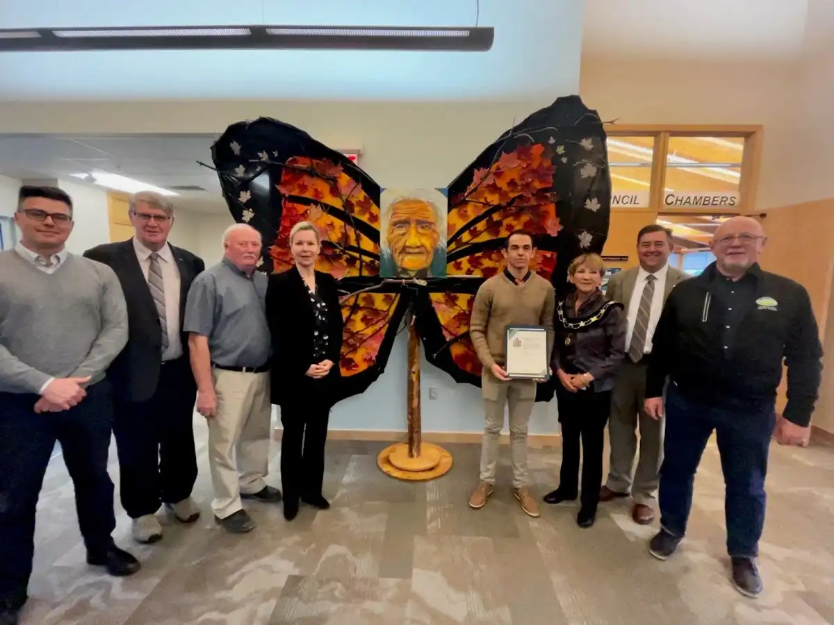 Northumberland County Council members and artist Pedro Antonio Martinez Zamudio standing around his monarch inspired art installation 